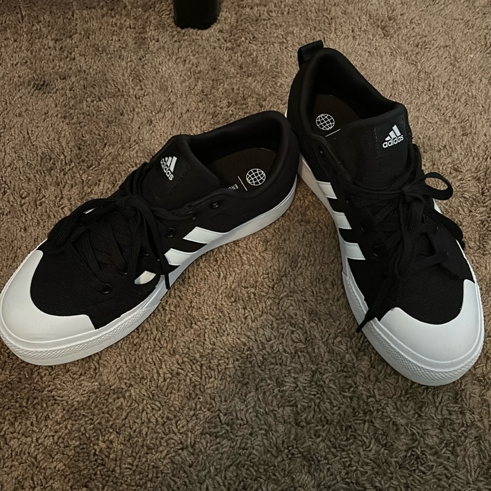 Black and white adidas shoes.